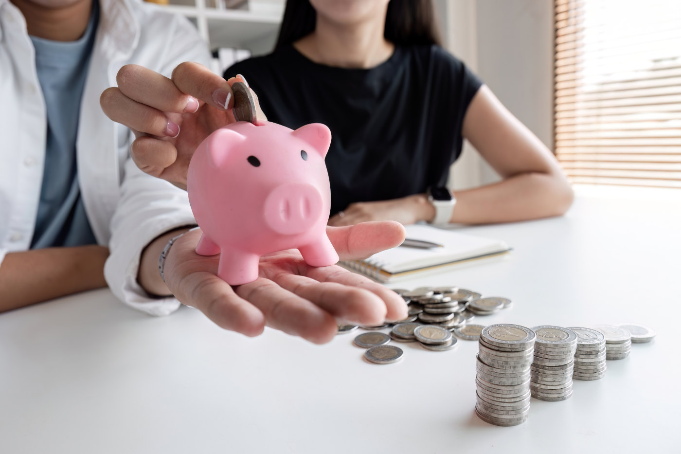 Happy family of four sitting together at home reviewing household budget and savings plan
