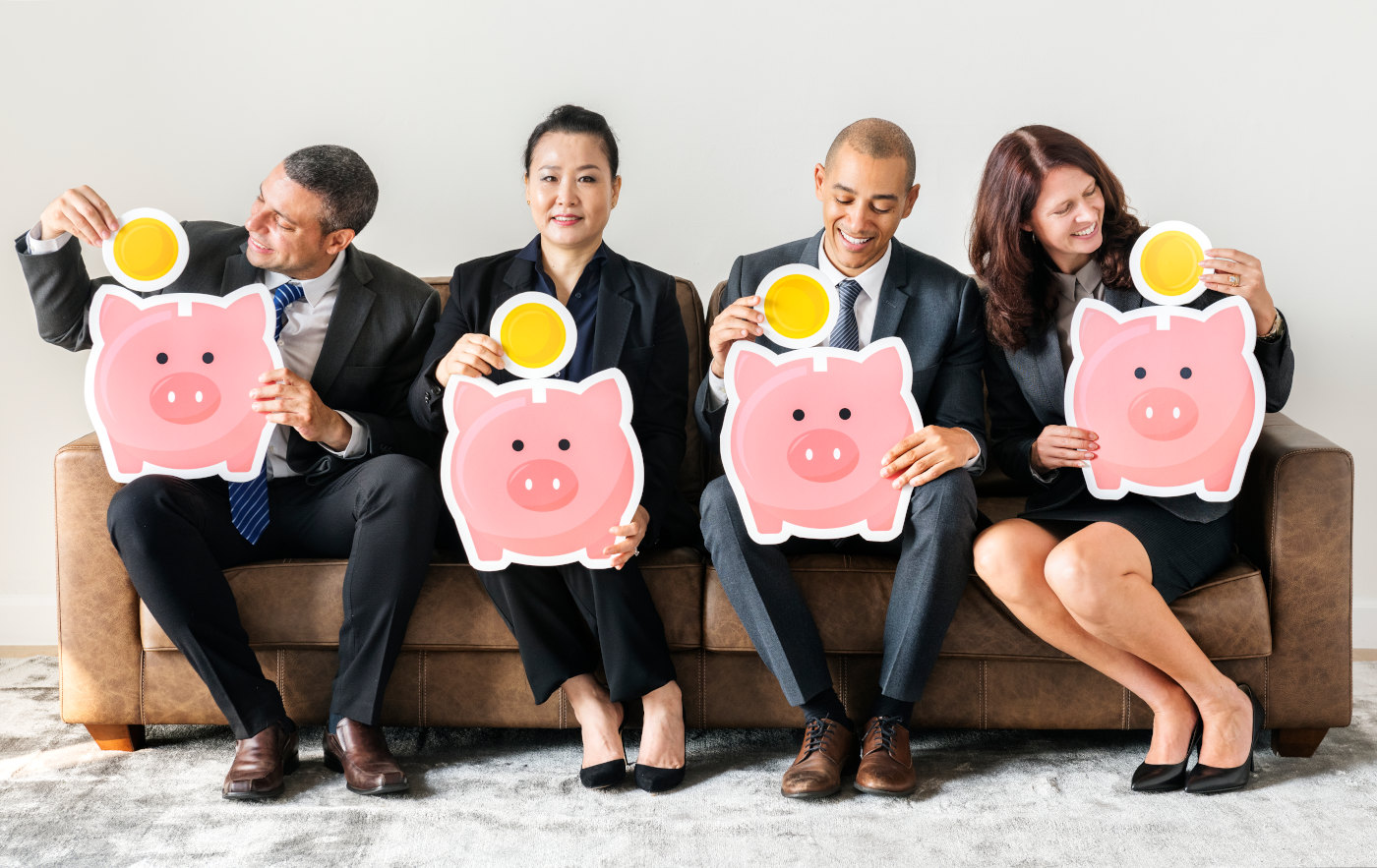Group of diverse financial advisors in professional setting with piggy banks representing different investment options