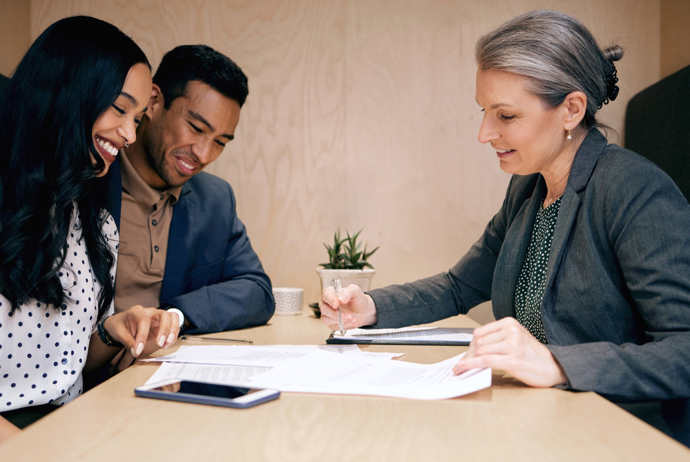 Financial professional analyzing retirement calculations on computer with spreadsheets and financial documents